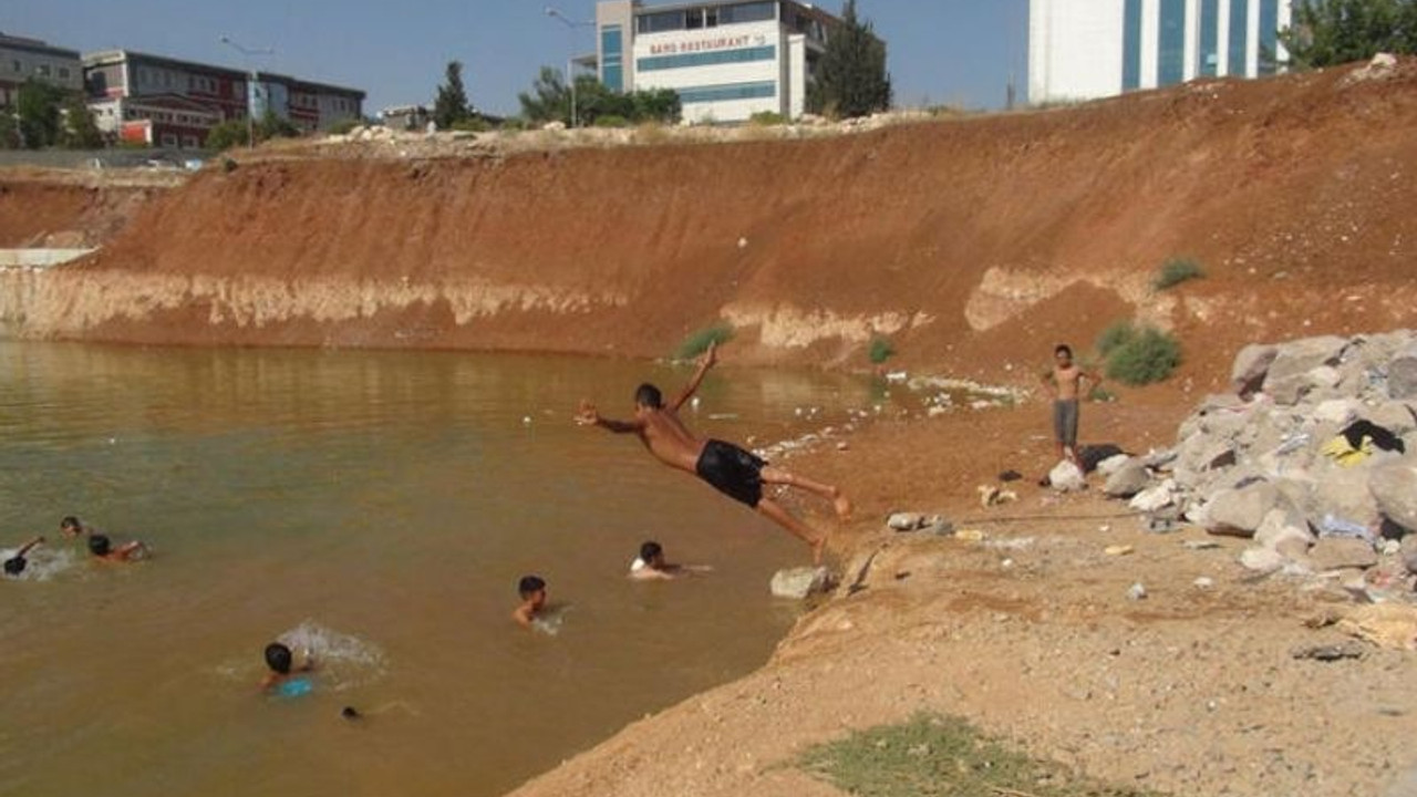 Adliye ek hizmet binasının temelini dolduran kirli su, çocukların yüzme alanı oldu