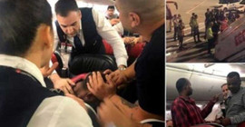 Havada panik, oksijen tüpüyle kokpite saldırmaya çalıştı