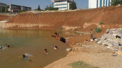 Adliye ek hizmet binasının temelini dolduran kirli su, çocukların yüzme alanı oldu